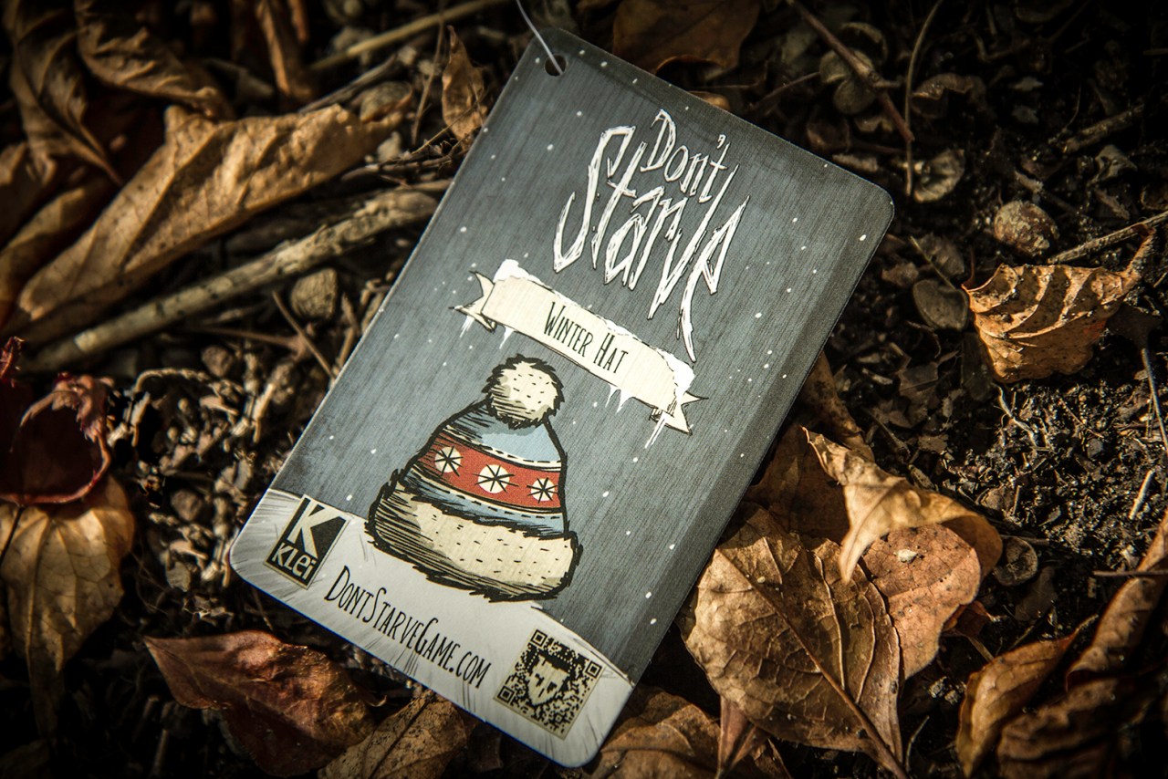 The tag for a Don't Starve Winter Hat in the art style of the game. It includes the Klei logo and the URL for the game's website.